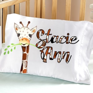 May include: White pillowcase with a giraffe illustration and the name "Stacie Ann" printed in brown and black text.