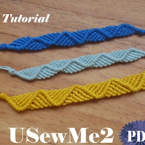 May include: Three handmade macrame bracelets in blue, light blue, and yellow, with a zig-zag pattern. The word "Tutorial" is at the top, and "USewMe2 PDF" is at the bottom. The bracelets are displayed on a wooden surface.