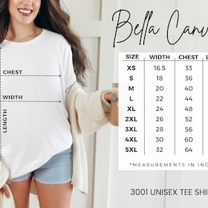 May include: White Bella Canvas 3001 unisex tee shirt with size chart. The chart shows measurements in inches for chest, width, and length, ranging from XS to 5XL. The shirt is being modeled.