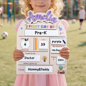 May include: A wooden sign held by a child, featuring the name "Amelia" and details for the first day of Pre-K. The sign includes the child's age (4 years), height (39 inches), favorite color (purple), teacher's name, and aspirations to be a doctor.