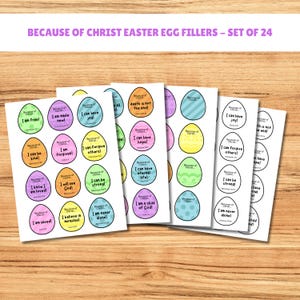 Puede incluir: Hojas de rellenos de huevos de Pascua con mensajes inspiradores como "¡Soy libre!" y "¡Puedo tener alegría!" en varios colores. El texto "BECAUSE OF CHRIST EASTER EGG FILLERS - SET OF 24" está en la parte superior.