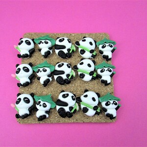 15 Pandas playing with bamboo. Some are wearing leaf hats and holding bamboo and bamboo shoots. Each panda is about 1 inch tall. They come in a metal box with window.