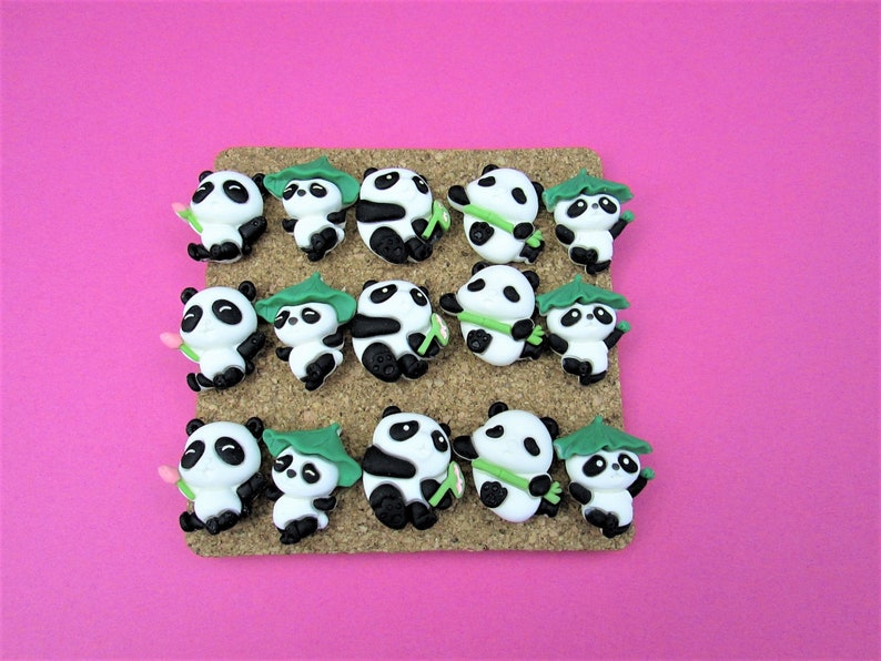 15 Pandas playing with bamboo. Some are wearing leaf hats and holding bamboo and bamboo shoots. Each panda is about 1 inch tall. They come in a metal box with window.