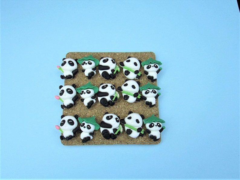15 Panda Push Pins. Each Panda is holding something like bamboo or wearing a bamboo leaf hat.