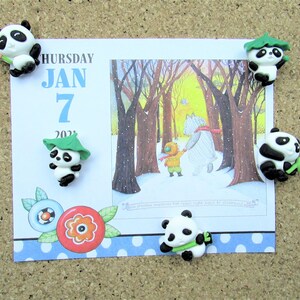 15 Pandas playing with bamboo. Some are wearing leaf hats and holding bamboo and bamboo shoots. Each panda is about 1 inch tall.
