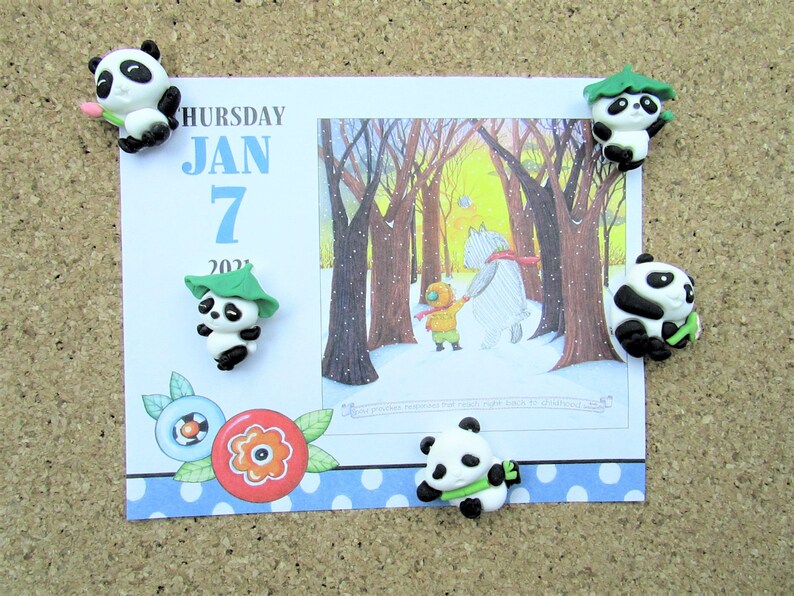 15 Pandas playing with bamboo. Some are wearing leaf hats and holding bamboo and bamboo shoots. Each panda is about 1 inch tall.