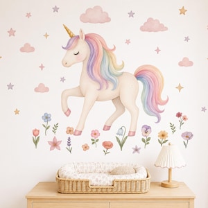 May include: A wall decal set featuring a cream-coloured unicorn with a pastel rainbow mane and tail, a gold horn, and closed eyes. The design includes scattered pink clouds, gold and purple stars, and various colourful flowers arranged below the unicorn.