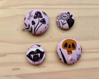 Halloween fabric button magnets in fun Sugar Skull, pumpkin, and festive prints.