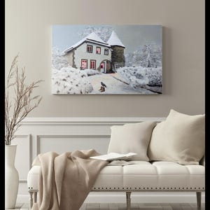 May include: A snowy winter scene with a small house with lit windows and a bird standing on a pair of boots. The house has a white roof and a stone exterior. The scene is framed in a white frame.