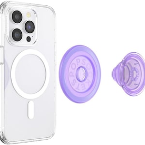 May include: A clear phone case with a white magnetic ring and a purple PopSockets grip. The PopSockets grip has the brand name printed on it. The phone case is designed to protect the phone while allowing for easy attachment of accessories.