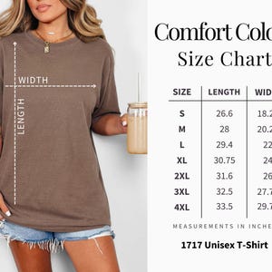 May include: A woman wearing a brown Comfort Colors t-shirt, with a size chart displayed. The chart shows measurements in inches for sizes S to 4XL, with the text "1717 Unisex T-Shirt".