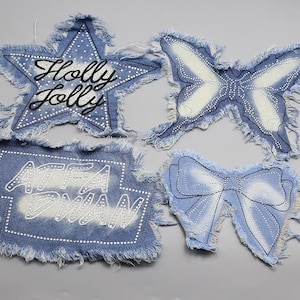 May include: Four denim patches in various shapes: a star with "Holly Jolly" text, a butterfly, a rectangle with "ATFA DWAN" text, and a bow. Each patch has a frayed edge and is embellished with white dots.
