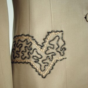 Soutache and beaded detail on suit that looks like "pockets".
