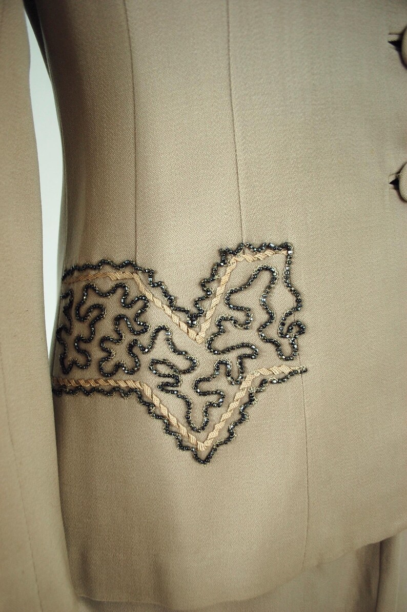 Soutache and beaded detail on suit that looks like "pockets".