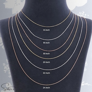 May include: Six delicate metal link chains displayed on a dark bust, featuring varying lengths labeled 14 inch, 16 inch, 18 inch, 20 inch, 22 inch, and 24 inch. The chains alternate between gold, silver, and rose gold tones in a layered arrangement.