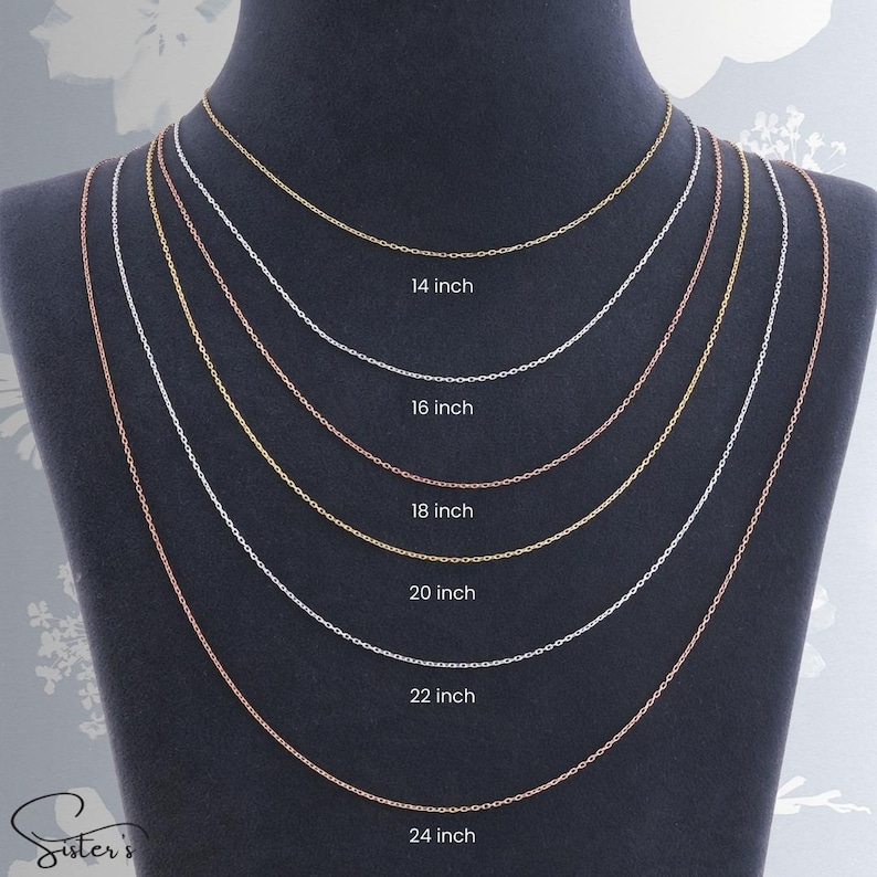 May include: Six delicate metal link chains displayed on a dark bust, featuring varying lengths labeled 14 inch, 16 inch, 18 inch, 20 inch, 22 inch, and 24 inch. The chains alternate between gold, silver, and rose gold tones in a layered arrangement.