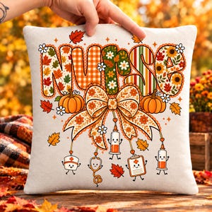 May include: A square off-white throw pillow featuring the word NURSE in large, patterned letters decorated with autumn leaves, sunflowers, and plaid. Below, a large floral bow hangs with cartoon medical icons including a syringe and clipboard.