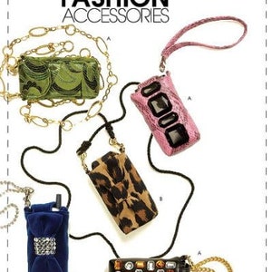 May include: Four different cell phone cases with chains. The cases are green with a floral pattern, pink with a snakeskin pattern, leopard print, and black with colorful jewels. The text "McCall's Fashion Accessories" is at the top of the image.