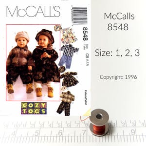 May include: McCalls sewing pattern number 8548 for Cozy Togs, sizes 1, 2, and 3. The pattern includes instructions for making children's clothing, including a jacket, pants, and a dress.