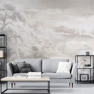 Może przedstawiać: Zestaw trzech ceramicznych kubków z nakrapianym, matowym wykończeniem. Kubki są w odcieniach kremu, jasnoszarym i ciemnoszarym. Każdy kubek ma prosty, minimalistyczny design.