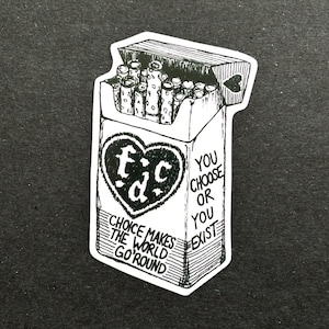 May include: Black and white sticker depicting an open cigarette packet with cigarettes visible. The packet features a heart-shaped design with "f.c.d" inside. Text on the packet reads "Choice makes the world go 'round" and "You choose or you exist."