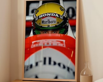 Op de afbeelding: Een close-up van een raceautocoureur die een gele en groene helm draagt met het woord "HONDA" en "Marlboro" erop. De coureur kijkt recht in de camera. De rode en witte vleugel van de auto bevindt zich op de voorgrond.