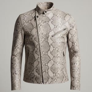 Può includere: Giacca in pelle con motivo a pelle di serpente, con chiusura a zip asimmetrica e piccolo collo a lupetto. La giacca presenta una palette di colori neutri di grigio, beige e marrone, con una sottile lucentezza. Design classico da giacca da motociclista.