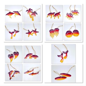 May include: A set of 12 colorful, hand-painted wooden ornaments featuring various ocean-themed designs, including starfish, jellyfish, dolphins, and sea turtles. Each ornament is painted in shades of red, orange, and yellow, creating a vibrant and festive look.