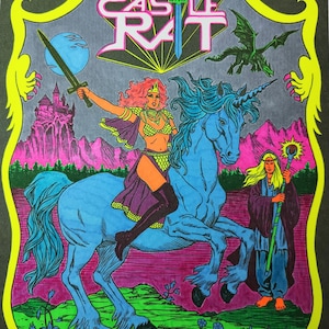 May include: Fantasy art print featuring a woman riding a blue unicorn, holding a sword. The artwork includes a castle, a dragon, and a wizard. The title "Castle Rat" is displayed at the top, framed with a yellow border.