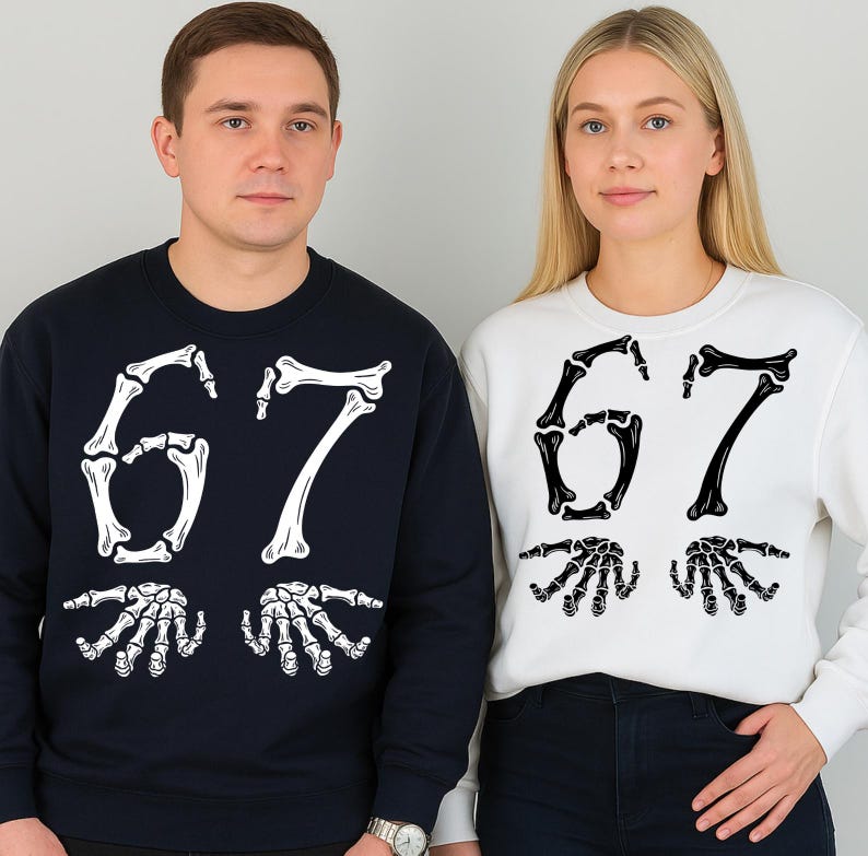 May include: Two crew neck sweatshirts, one navy blue and one white. Each sweatshirt features the number "67" in a bone-like font, with skeletal hands below. The sweatshirts are worn by two people.