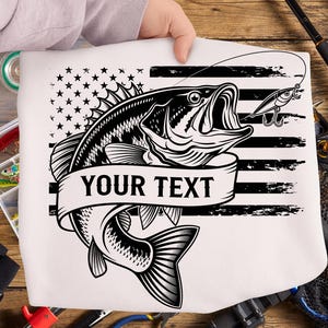 May include: White graphic featuring a black and white illustration of a largemouth bass with an open mouth, a fishing lure, and an American flag design. The banner reads "YOUR TEXT".