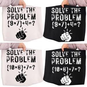 May include: Four tote bags, two white and two black, each featuring the text "SOLVE THE PROBLEM" with a math equation and a pointing hand graphic. The equations are (9*7)+4=? and (10*6)+7=?.