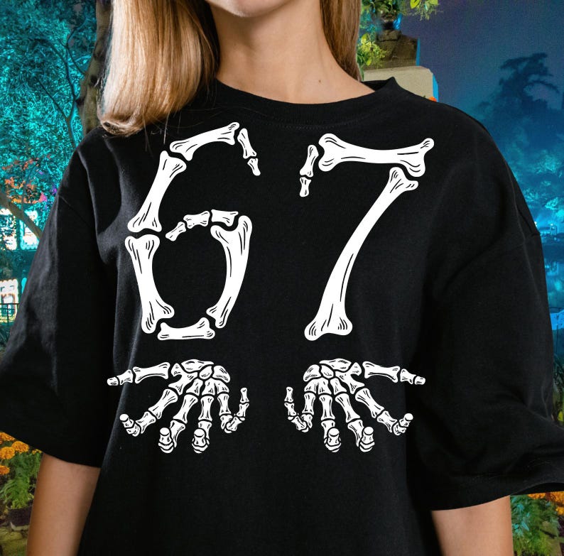 May include: Black t-shirt with a white skeleton bone design. The design features the number "67" in a bone font, with two skeletal hands below. The shirt is a casual, crew neck style.
