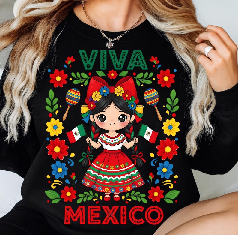 May include: Black sweatshirt with a colorful graphic featuring a cartoon girl in a traditional Mexican dress, holding Mexican flags. The design includes the words "VIVA MEXICO" and decorative flowers and maracas.