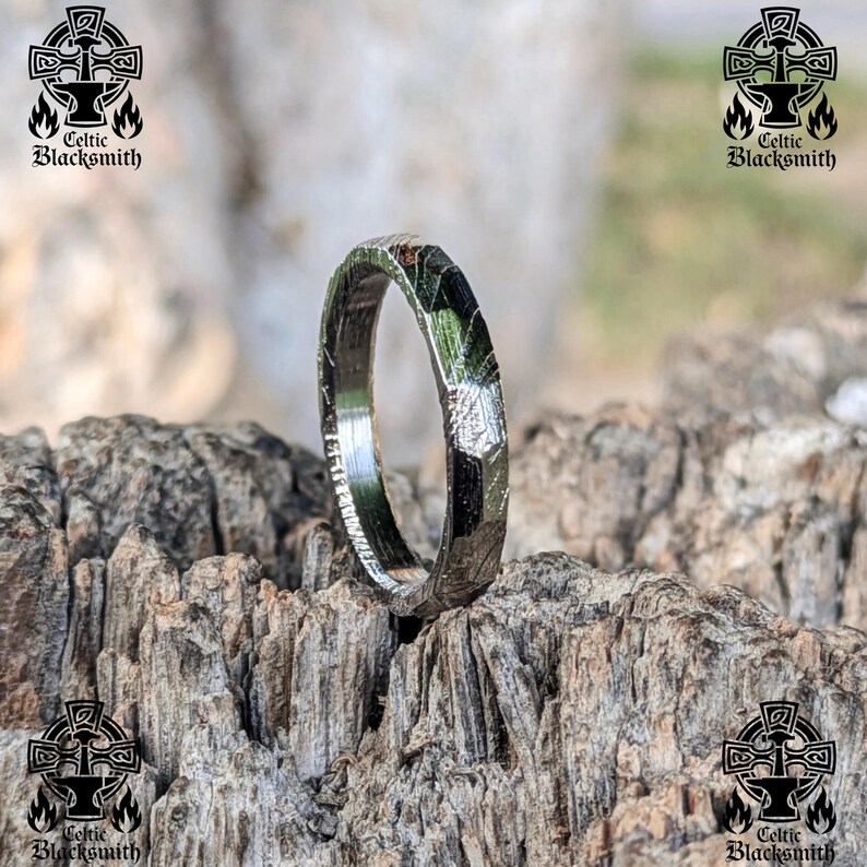 May include: A silver ring with a textured, hammered finish. The ring is made of metal and has a unique, organic look.