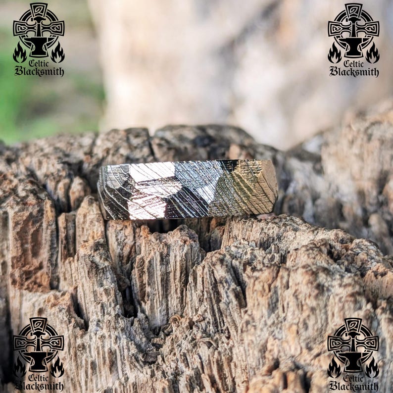 May include: A silver ring with a hammered finish. The ring is made of meteorite metal and has a unique pattern.