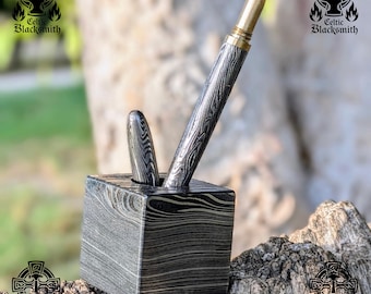 May include: A pen and pencil set in a square pen holder. The pens and holder have a unique, patterned design in shades of gray and black. The pen has a gold-colored tip. The Celtic Blacksmith logo is visible in the background.