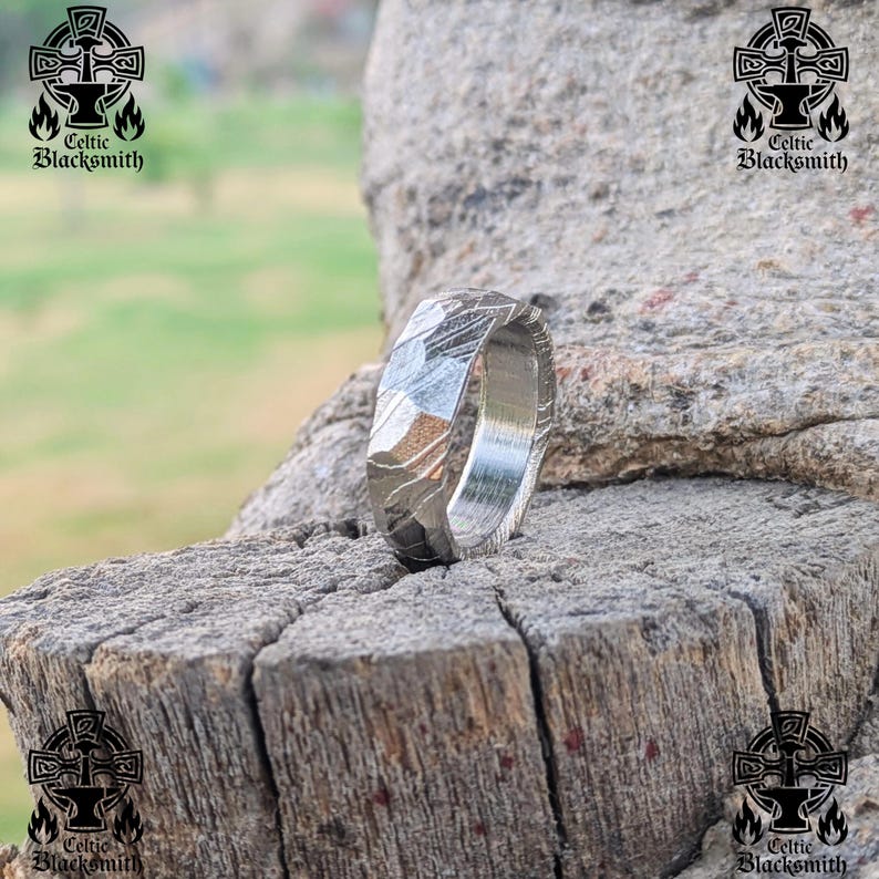 May include: A silver ring with a textured, hammered finish. The ring is made of meteorite metal and has a unique, natural pattern.
