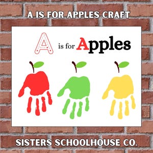 May include: A white sign with the text "A is for Apples Craft" and "SISTERS SCHOOLHOUSE CO." Three apple designs are made from handprints in red, green, and yellow. The letter "A" is outlined in red.
