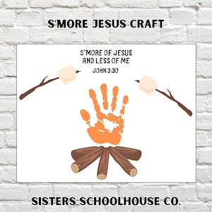 May include: A white print with the text "S'MORE JESUS CRAFT" at the top and "S'MORE OF JESUS AND LESS OF ME JOHN 3:30" in the center. The image includes a handprint, marshmallows on sticks, and a campfire. The bottom of the print reads "SISTERS SCHOOLHOUSE CO."