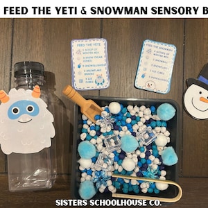 May include: A sensory bin with a winter theme, featuring a clear bottle with a yeti graphic, a tray filled with blue and white sensory items, and cards with instructions. The text "FEED THE YETI & SNOWMAN SENSORY BIN" is at the top.