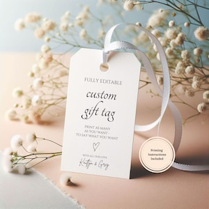 May include: A white custom gift tag with a white ribbon, featuring the text "FULLY EDITABLE custom gift tag" and "PRINT AS MANY AS YOU WANT - TO SAY WHAT YOU WANT". The tag includes a heart symbol and the names "Kaitlyn & Greg".