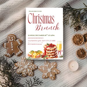 May include: A Christmas Brunch invitation with text in red script. The invitation includes illustrations of food and drink, such as eggs benedict, a stack of pancakes, and a mimosa. Gingerbread and snowflake cookies are arranged around the invitation.