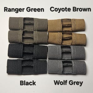 May include: A set of eight elastic straps in four different colors: ranger green, coyote brown, black, and wolf grey. Each strap has three slits for attaching to a variety of items.
