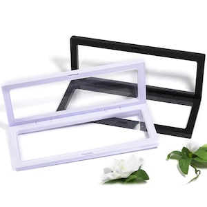 May include: Two clear display boxes with black frames. The top box is open and the bottom box is closed. The boxes are made of plastic and have a clear view of the inside.