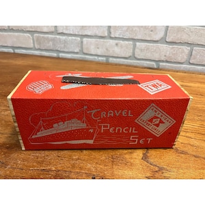May include: A vintage red Travel Pencil Set box with silver lettering and illustrations. The box features a ship, the words "Travel Pencil Set", and logos for TWA, Union Pacific, and American Export Lines.