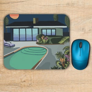 May include: A rectangular mouse pad featuring a graphic illustration of a house with a swimming pool at night. The scene includes a lounge chair, tropical plants, and a dark sky with a round orange sun or moon. A metallic blue computer mouse sits nearby.