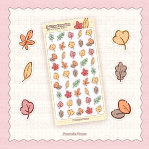 Könnte beinhalten: Ein Bogen dekorativer Aufkleber zum Thema Herbst mit verschiedenen Blattdesigns in Rot-, Orange-, Gelb- und Grüntönen. Der Bogen ist mit "Fall Leaf Doodles" beschriftet und enthält den Markennamen "Francie Plans".