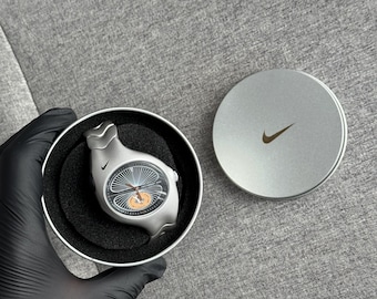 The Nike Triax Armored Chrono watch is a classic model with an innovative design, a retro-inspired accessory silver avantgarde y2k