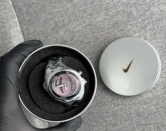 The Nike Triax Armored Chrono watch is a classic model with an innovative design, a retro-inspired accessory silver chrome avantgarde y2k